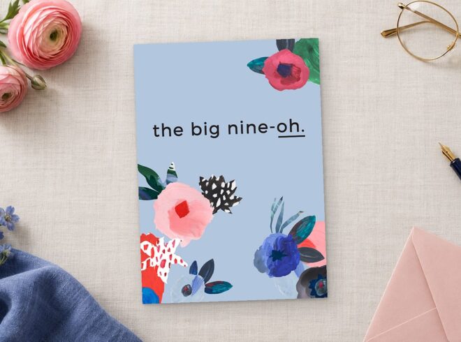 Paperlust Abstract Floral invitation in periwinkle blue with painted pink and red flowers reads the big nine oh on linen.