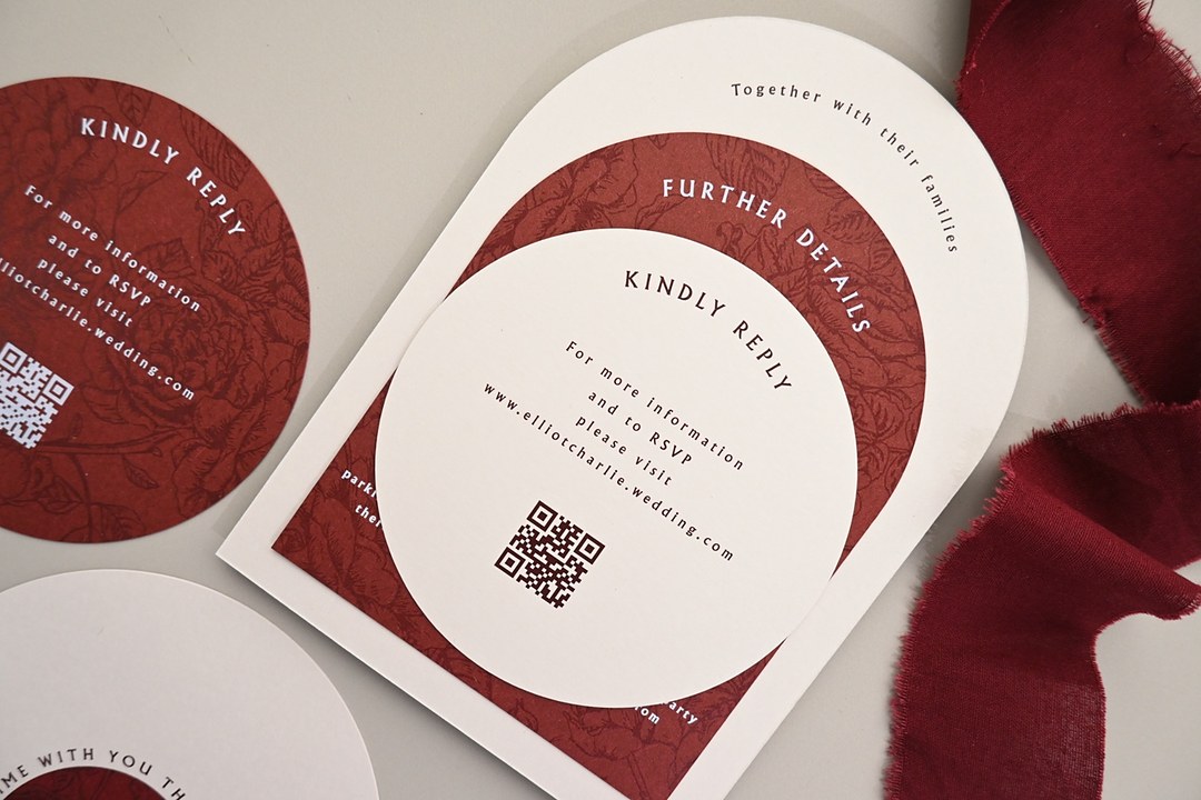 Paperlust Array stationery layers cream and burgundy cards on gray with an arch reading Together with their families.